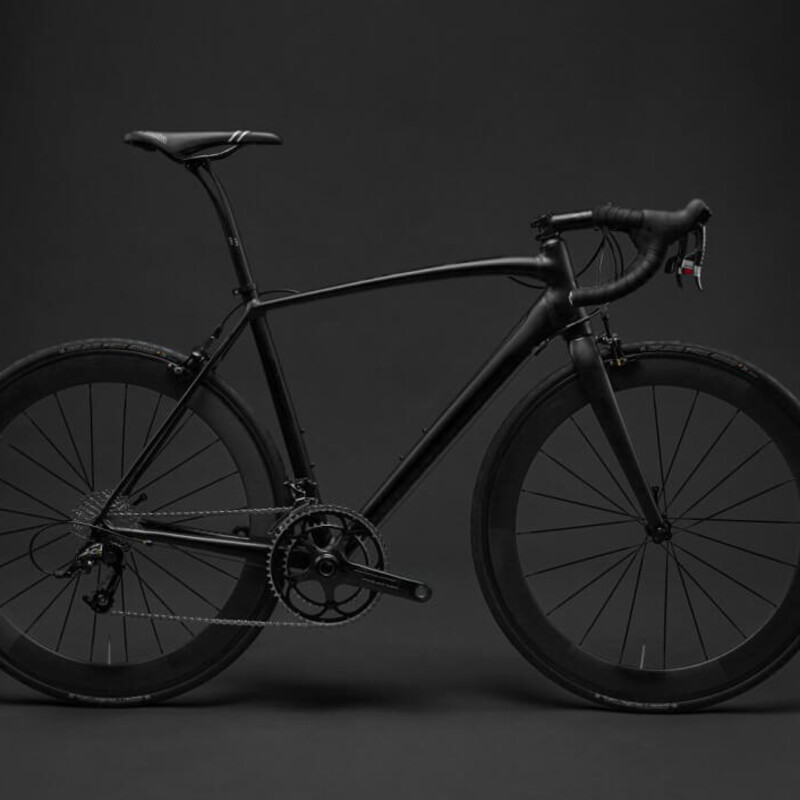 Black bike in front of a black background. Yay for contrast!